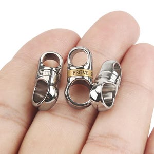 May include: Three silver metal clasps with a gold band and engraved text. The clasps are labeled "FEGVE" and "VE.CHINA".