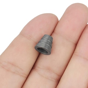 May include: A gray metal cone-shaped cord end cap with a smooth surface and three ridges.