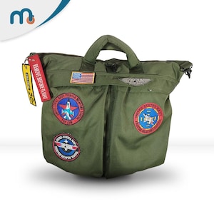 May include: An olive green Top Gun Maverick flight bag with various patches, including the American flag and United States Navy Fighter Weapons School. It has a top handle and a "REMOVE BEFORE FLIGHT" tag.