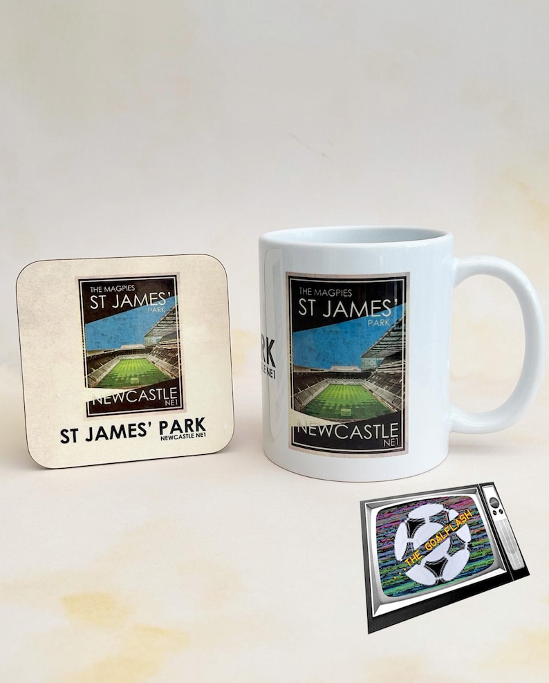 May include: A white mug and coaster with a black and white image of St. James' Park, the home of Newcastle United Football Club. The text "The Magpies St. James' Park Newcastle Net" is printed on both the mug and coaster. A black and white television with a soccer ball and the text "The Goalflash" is also shown.