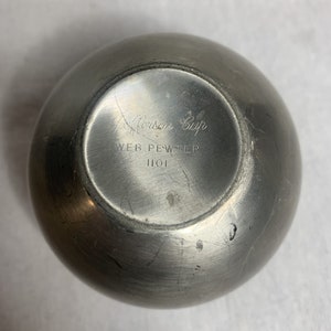 May include: A silver pewter cup with the inscription "Alison Cup" and "Web Pewter 1101" on the bottom.