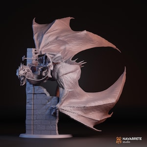 May include: A detailed sculpture of a dragon with large wings, perched on a stone structure. The dragon has an open mouth, revealing sharp teeth, and is adorned with a saddle. The sculpture is a light grey colour and has a textured surface.