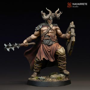 May include: A detailed figurine of a warrior with large horns on his helmet, holding a spiked mace and a wooden shield. The figure is clad in brown and tan armour, with a red cape. The base is dark, and the background is black.