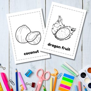 May include: Two black and white coloring pages featuring a coconut and a dragon fruit. The pages have a dashed border and the name of the fruit is written below the image.