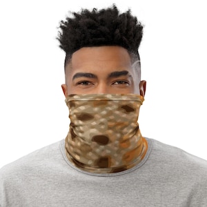 May include: A person wearing a face covering with a brown and beige camouflage pattern.