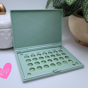 Interior of open mint green pill case – shows how your specific pill pack fits snugly in this compact and travel-ready holder.