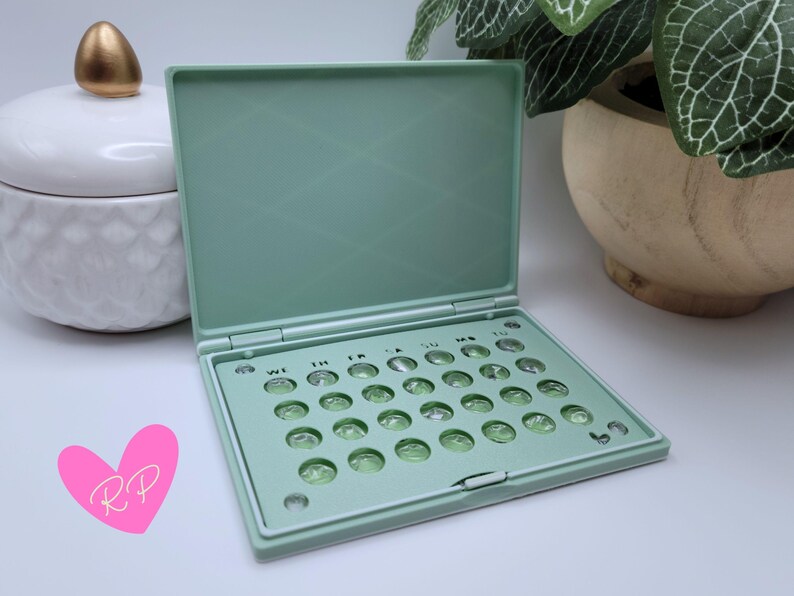 Interior of open mint green pill case – shows how your specific pill pack fits snugly in this compact and travel-ready holder.