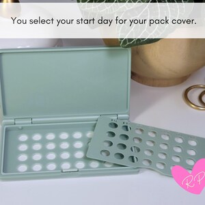 Open mint sea green birth control pill case with day-of-the-week pack cover leaning on it – shows secure cover system that marks your start day and holds the pill pack in place.