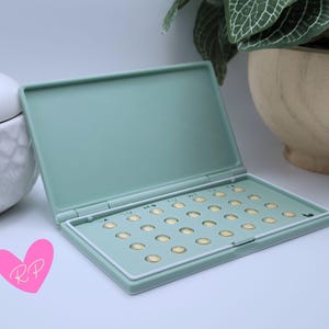 Interior of open mint green pill case – shows how your specific pill pack fits snugly in this compact and travel-ready holder.