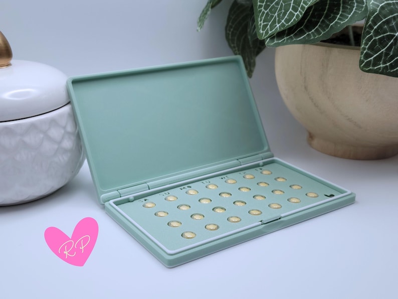 Interior of open mint green pill case – shows how your specific pill pack fits snugly in this compact and travel-ready holder.