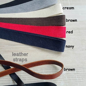 May include: Assortment of cotton webbing straps in black, gray, cream, brown, red, and navy.  Leather straps in brown and black.