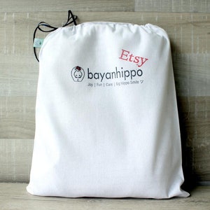 May include: White cotton drawstring bag with the text "Etsy" and "bayanihippo Joy | Fun | Care | Big Hippo Smile" printed on it.