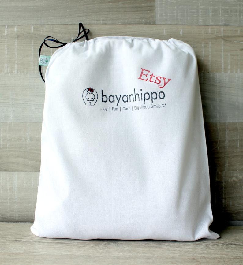 May include: White cotton drawstring bag with the text "Etsy" and "bayanihippo Joy | Fun | Care | Big Hippo Smile" printed on it.