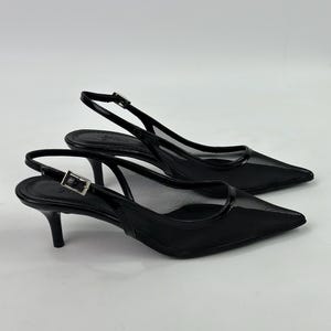 May include: Black mesh slingback heels with a pointed toe and a small heel.