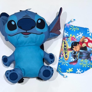 May include: A blue Stitch plush backpack with a matching blue drawstring bag. The backpack features Stitch's face and body. The drawstring bag has a blue background with a graphic of Lilo and Stitch. The bag has a white drawstring.
