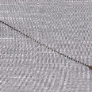May include: A long, slender metal hat pin featuring a pointed tip and a smooth, teardrop-shaped dark blue glass bead at the opposite end. The pin has a metallic silver-toned finish and a small gold-toned metal cap connecting the bead to the shaft.