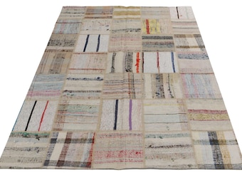 May include: A patchwork rug with a variety of colors and patterns. The rug is made of different fabrics and textures, and it has a rustic, vintage look.