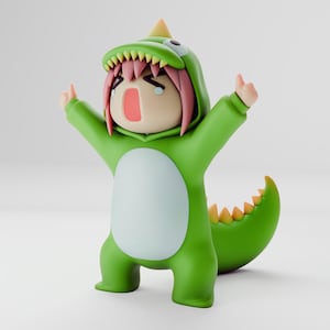 Könnte beinhalten: Eine grüne Dinosaurier-Figur mit weißem Bauch und gelber Flosse am Schwanz. Die Figur hat eine Kapuze mit einem Dinosaurierkopf und rosa Haaren. Die Figur weint und hat die Arme erhoben.