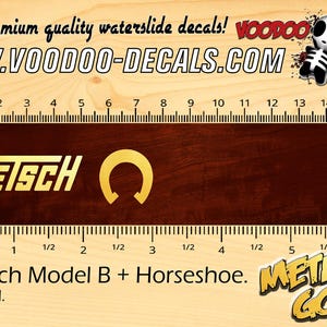 Op de afbeelding: Een waterslide decal met een gouden Gretsch-logo en een hoefijzer. De decal is gelabeld "Metallic Gold" en is voor een Gretsch Model B gitaar.