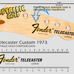 May include: A close-up of a light wood guitar headstock with a gold metallic "Telecaster Custom 1973" decal. The decal features the Fender logo and the words "Metallic Gold Contour Logo". The headstock is 7.22 inches (18.33 cm) long.