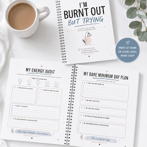 May include: A spiral-bound journal titled I'M BURNT OUT BUT TRYING with a gentle reset journal for overwhelmed adults subtitle. The open pages show My Energy Audit and My Bare Minimum Day Plan sections with prompts, checkboxes, and lines for writing.