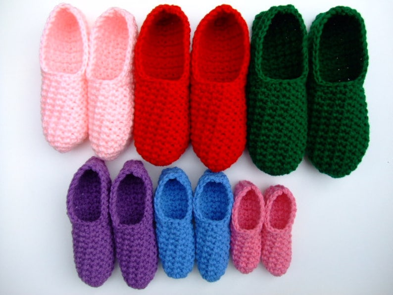 May include: A set of crocheted slippers in various colors, including pink, red, green, purple, blue, and light pink. The slippers are arranged in pairs, with the largest pair at the top and the smallest pair at the bottom.