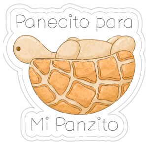Op de afbeelding: Een sticker met een cartoon schildpad in een broodachtige schaal. De schildpad is lichtbruin en de schaal is een lappendeken van bruinachtige vierkanten. De tekst "Panecito para Mi Panzito" staat boven en onder de schildpad.