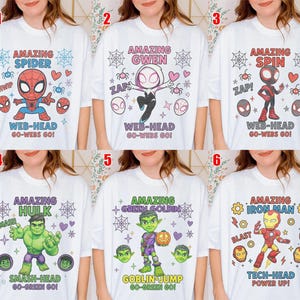 May include: A collection of six white t-shirts featuring cartoon character graphics. Designs include Spider-Man, Gwen, Spin, Hulk, Green Goblin, and Iron Man, each with character-specific text, spider webs, hearts, and various icons printed on the front.