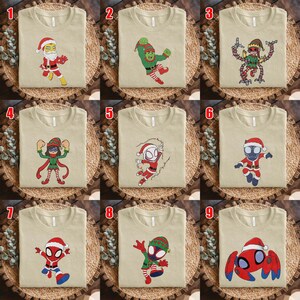 May include: A collection of nine beige t-shirts, each featuring a unique cartoon character dressed in holiday attire. The designs include characters in Santa suits, elf costumes, and festive gear, displayed in a grid layout numbered one through nine.