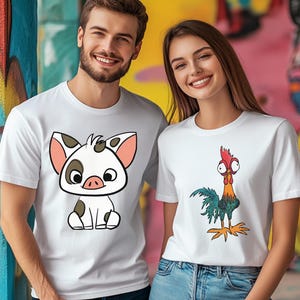 Puede incluir: Dos camisetas blancas de manga corta. Una camiseta presenta un cerdo de dibujos animados con manchas negras y ojos grandes. La otra muestra un gallo de dibujos animados con cresta roja, ojos muy abiertos y plumas coloridas. Cuello redondo.