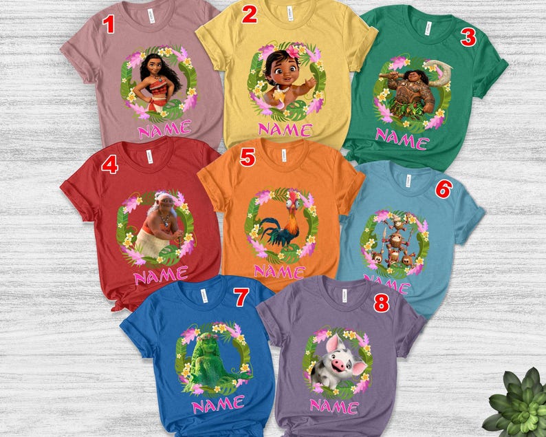 May include: Eight short-sleeved t-shirts in various colors, each featuring a unique Moana character graphic inside a floral wreath and the word NAME printed in pink. The shirts are numbered one through eight and display characters like Moana, Maui, Hei Hei, Pua, and Kakamora.