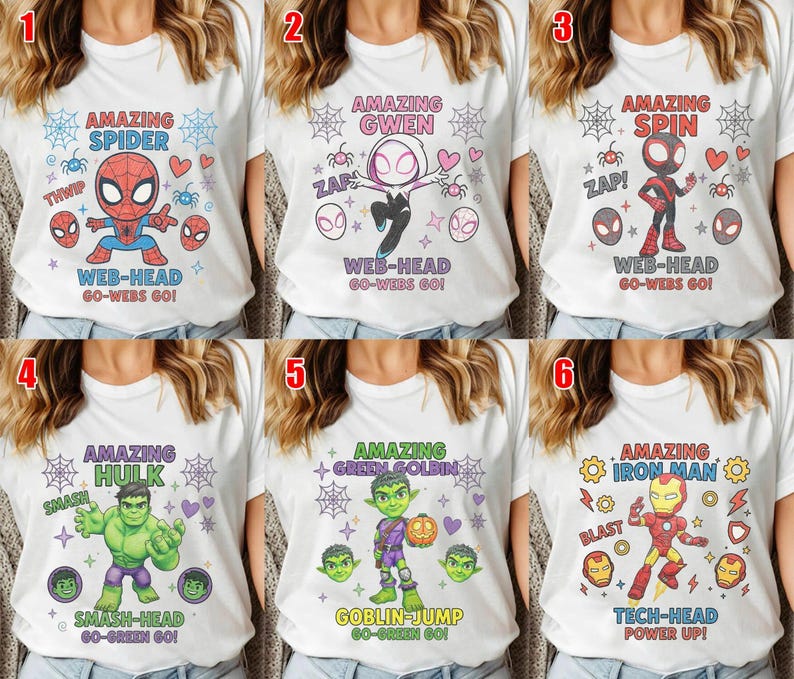 May include: A collection of six white t-shirts featuring cartoon superhero graphics. Each shirt displays a character with themed text including Amazing Spider Web-Head, Amazing Gwen Web-Head, Amazing Spin Web-Head, Amazing Hulk Smash-Head, Amazing Green Goblin Goblin-Jump, and Amazing Iron Man Tech-Head.