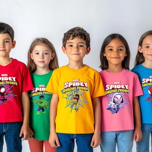 May include: A collection of five short-sleeved t-shirts in red, green, yellow, pink, and blue. Each shirt features the Marvel Spidey and His Amazing Friends logo with a graphic of a character including Spider-Man, Hulk, and Ghost-Spider.