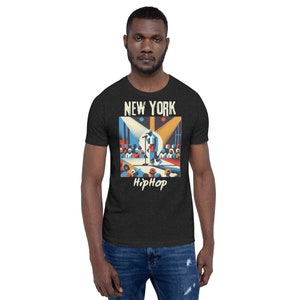 May include: A black t-shirt with a graphic print of a stylized image of a person performing on stage in front of a crowd. The text "NEW YORK" and "HipHop" are printed on the shirt.