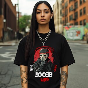 Loose Lips Sink Ships graphic tee for hustlers and streetwear lovers. Urban-style shirt with bold mask design and red grunge background. Printed on premium Comfort Colors 1717 for a relaxed, comfortable fit. Great gift for urban fashion enthusiasts.