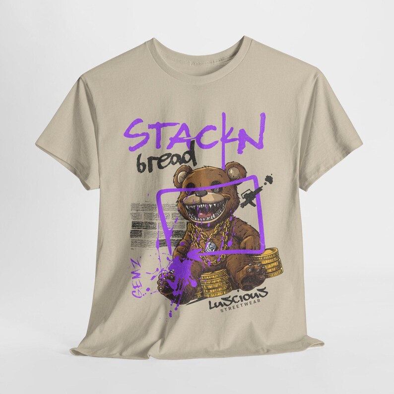 Unisex Stackin Bread Teddy Graphic T-Shirt in Sand Color with an eye-catching teddy bear design. Perfect for casual streetwear outfits or gifting, this shirt combines bold graphics with everyday wearability. Designed for fans of urban fashion.