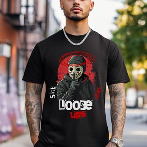 Urban streetwear 'Loose Lips Sink Ships' t-shirt with bold mask design and gritty grunge aesthetic. Perfect for hip-hop fashion, trap style outfits, and hustler apparel. High-quality print on Comfort Colors 1717 shirt and durable for everyday wear.