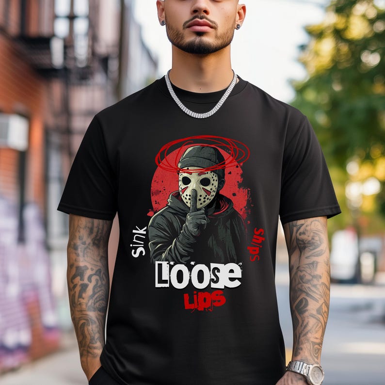 Urban streetwear 'Loose Lips Sink Ships' t-shirt with bold mask design and gritty grunge aesthetic. Perfect for hip-hop fashion, trap style outfits, and hustler apparel. High-quality print on Comfort Colors 1717 shirt and durable for everyday wear.