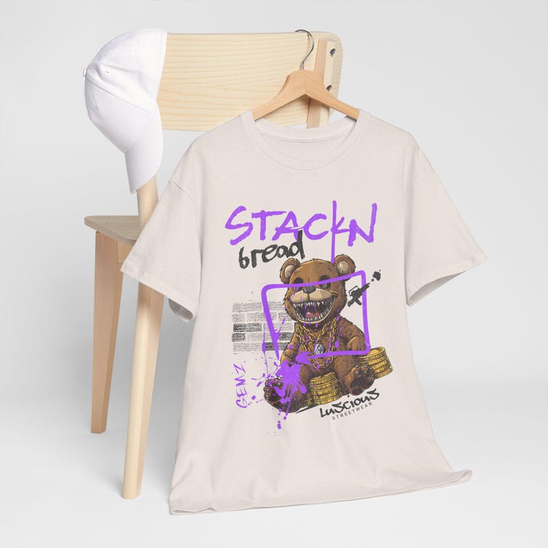 Stackin Bread Teddy Graphic T-Shirt in Ice Grey for men and women who love bold streetwear. With its striking teddy bear design and comfortable fit, this tee is ideal for casual looks or standout outfits. Perfect for fans of urban fashion.