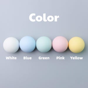 May include: A white ceramic mug with a black handle and the text "But First, Coffee" in a black, handwritten-style font. The mug is on a white surface.