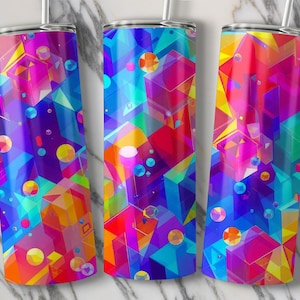 May include: Three stainless steel tumblers with abstract geometric designs in vibrant colors. The tumblers feature a mix of shapes, including cubes, spheres, and triangles, in shades of blue, purple, orange, and yellow. Each tumbler has a silver lid and a straw.