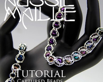 May include: A tutorial for making a captured beads bracelet. The bracelet is made with silver chainmail and iridescent purple, blue, and green beads. The text "TUTORIAL CAPTURED BEADS BRACELET" is displayed on the image.