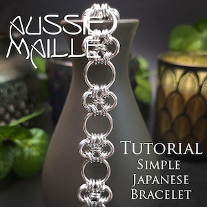 May include: A silver chainmail bracelet with a simple Japanese design. The bracelet is on a gray vase and the text "TUTORIAL SIMPLE JAPANESE BRACELET" is in the lower right corner of the image.