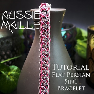 May include: A close-up of a silver and pink chainmail bracelet. The bracelet is made with small, interlocking metal rings. The bracelet is on a brown surface. The text "TUTORIAL FLAT PERSIAN 5IN1 BRACELET" is visible in the image.
