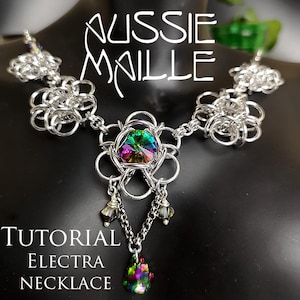 May include: A silver chain necklace with a large iridescent crystal in the center. The necklace is made of interlocking metal rings and has a flower-shaped design. The text "Aussie Malle" and "Tutorial Electra Necklace" is visible in the image.
