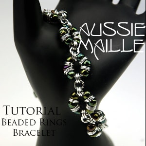May include: A tutorial for making a beaded ring bracelet. The bracelet is made with silver chain and iridescent green beads. The text "Aussie Maille" and "Tutorial Beaded Rings Bracelet" is visible in the image.