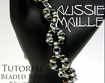 May include: A tutorial for making a beaded ring bracelet. The bracelet is made with silver chain and iridescent green beads. The text "Aussie Maille" and "Tutorial Beaded Rings Bracelet" is visible in the image.