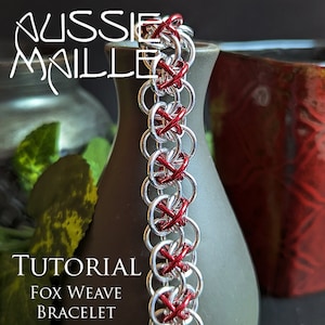 May include: A close-up of a red and silver chainmail bracelet. The bracelet is made with a fox weave pattern. The text "Tutorial Fox Weave Bracelet" is visible below the bracelet.