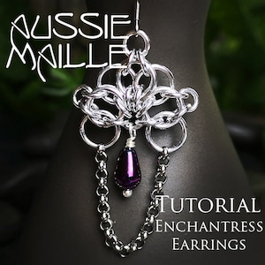 May include: Silver chainmail earrings with a purple teardrop bead. The earrings are in the shape of a flower and have a chain dangling from the bottom. The earrings are labeled "Tutorial Enchantress Earrings".