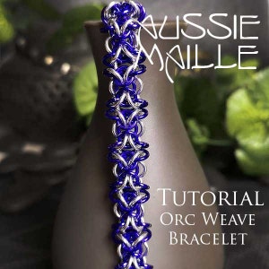 May include: A close-up of a blue and silver chainmail bracelet. The bracelet is made with small metal rings woven together in a pattern. The text "TUTORIAL ORC WEAVE BRACELET" is visible in the image.